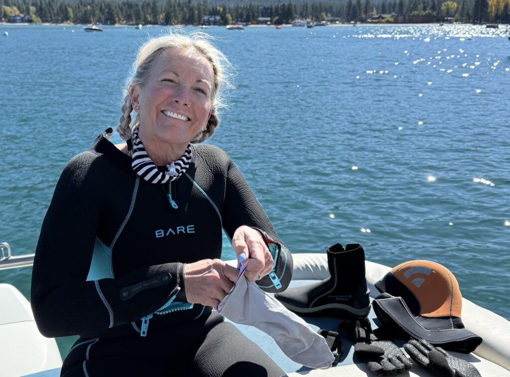 Scuba diver ascending through deep clear water at high altitude lake — altitude diving decompression safety